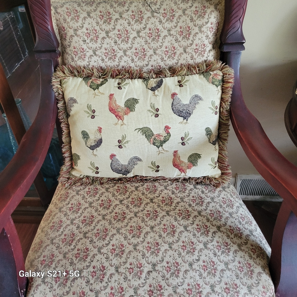 A vintage chicken accent pillow